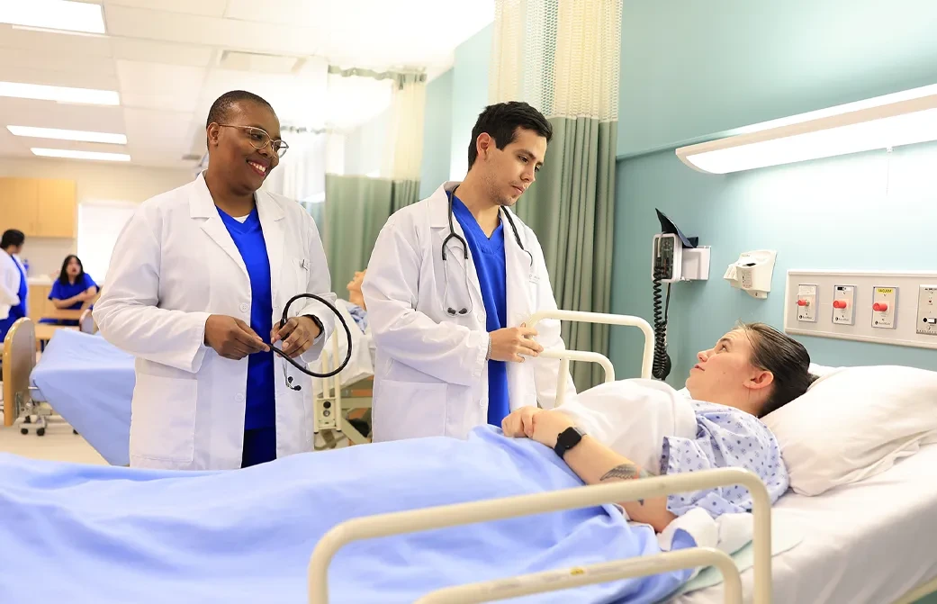 A Bachelor of Science in Nursing (BScN) students from Oulton College’s first cohort providing a testimonial in a lab setting, highlighting the hands-on learning approach of the accelerated three-year nursing program.