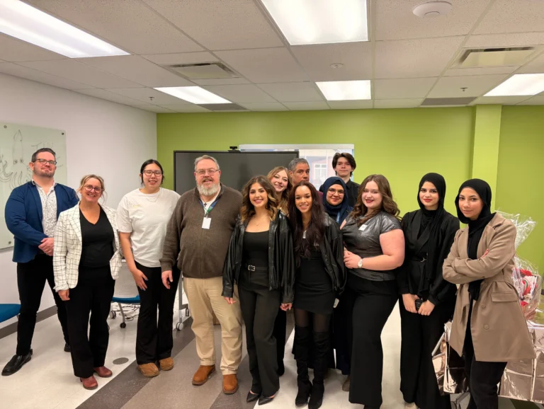 Is This Business Management & Entrepreneurship students at Oulton College. The students are around a table with an instructor after a Business administration and Business management concepts, as part of their BME program.