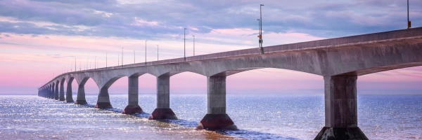 The bridge between Prince Edward Island and New Brunswick in the sunset, the sky is a beautiful blue purple.