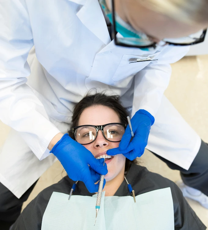 Dental Hygiene student working on a patient in the dental Clinic at Oulton College
